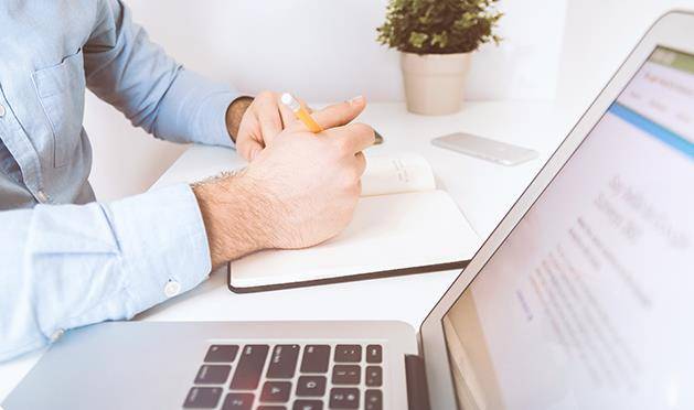 Man working on plan for outsourcing HR