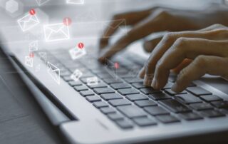 typing on laptop email icons