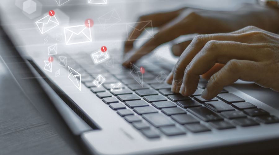 typing on laptop email icons