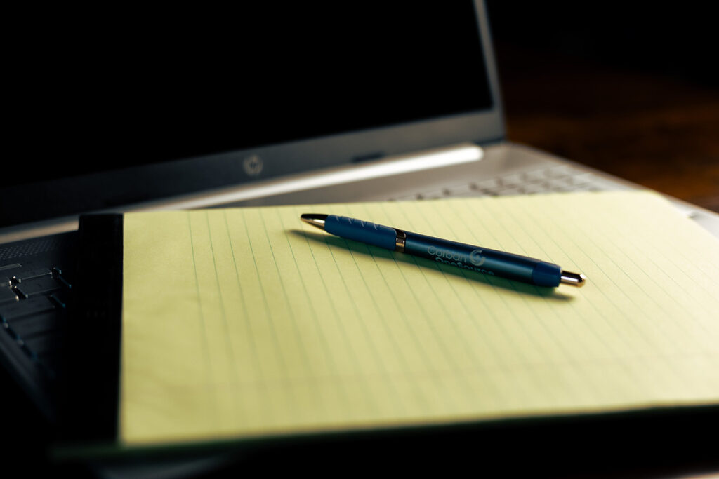 a pen sitting on a tablet sitting on an open laptop