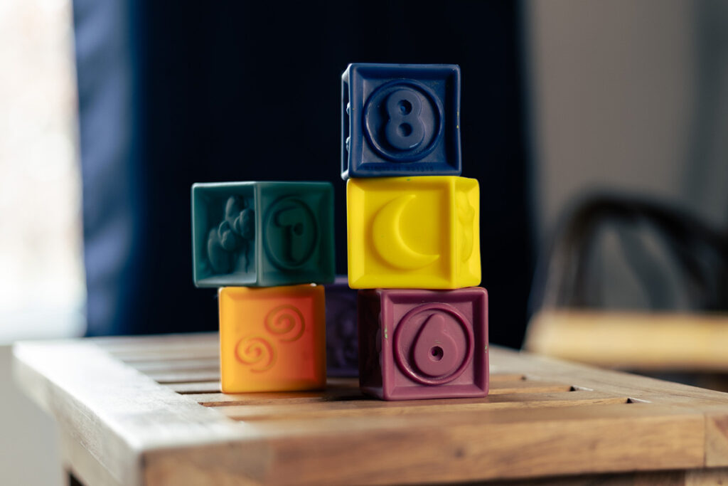 a stack of childrens blocks sitting on a small table