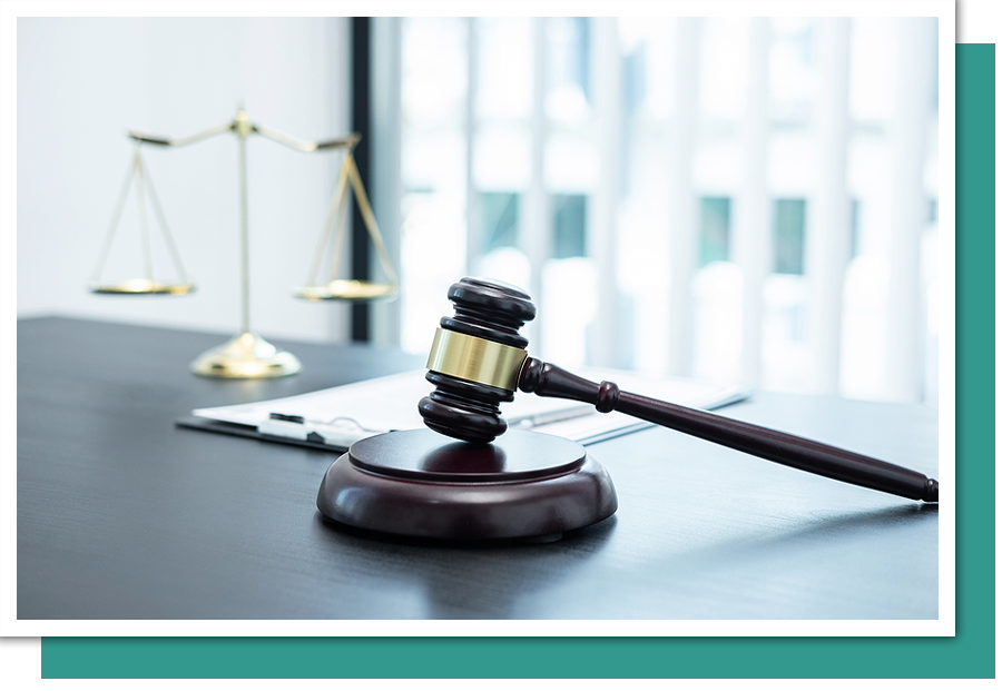 a gavel sitting on a desk with a scale in the background