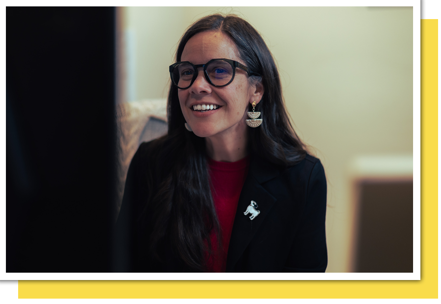 office woman smiling at she works on computer
