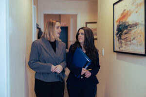 an HR director speaking to a subordinate while walking down a hallway