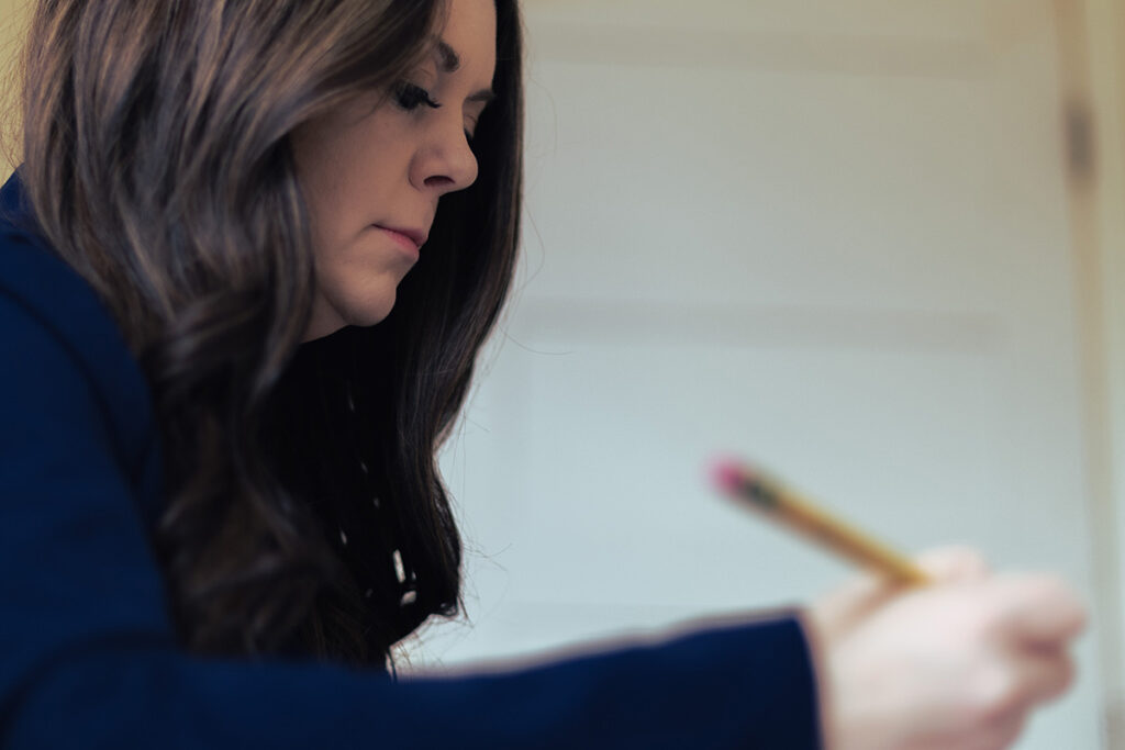 hr leader filling out paperwork with a pencil