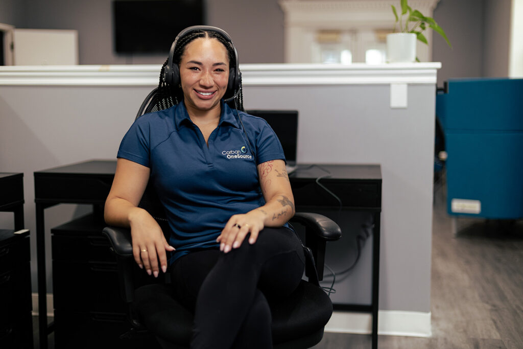 a friendly call center agent sitting at a workstation