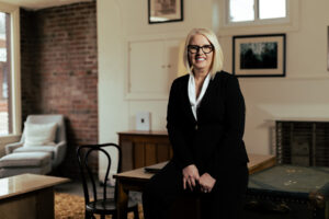 hr leader leaning confidently against her desk