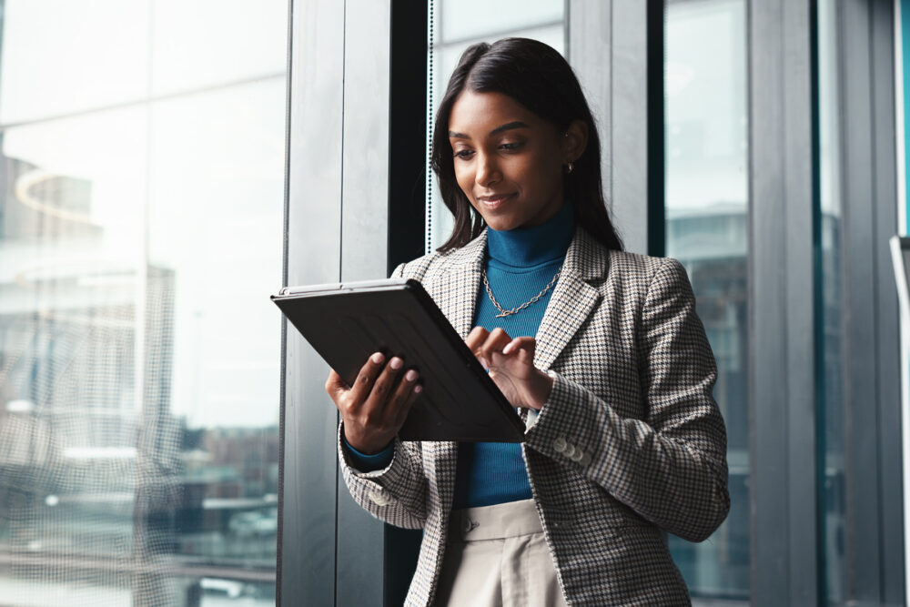 payroll manager reviewing payroll reports on a tablet
