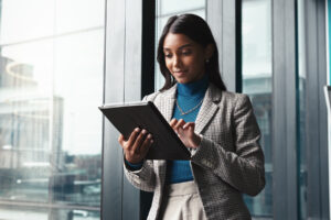 payroll manager reviewing payroll reports on a tablet