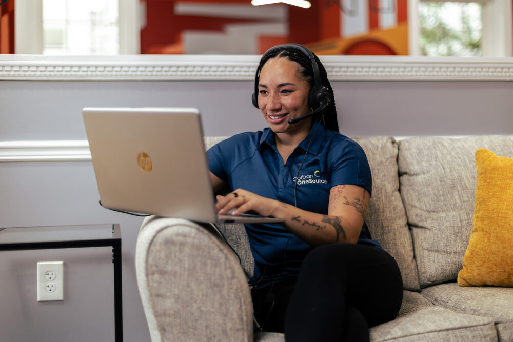 a corban onesource heroes team member working diligently with a client